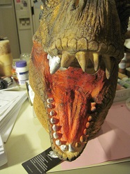 T-rex head mask with teeth partially painted