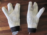 gloves covered with masking tape holding fingers in Vulcan salute