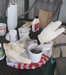 work area showing gloves in the process of being covered with liquid latex